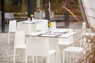 Set tables on the beautiful outdoor terrace of the restaurant in Martinsried near Munich.