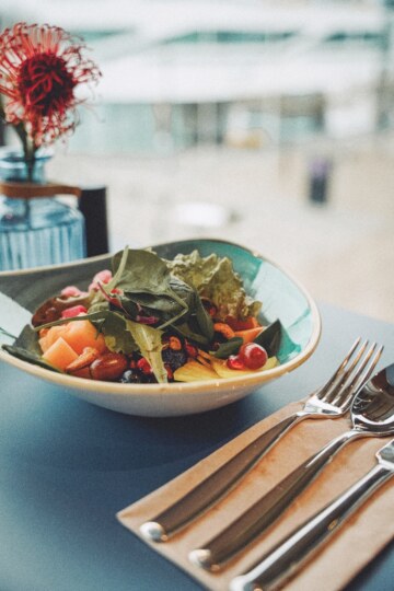 Healthy salad dish in a turquoise-colored bowl at the design hotel near Munich.