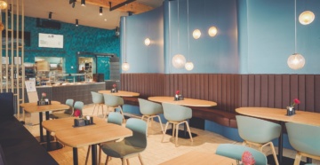 Food lounge "The Bowl" near Munich with cozy benches and seating.