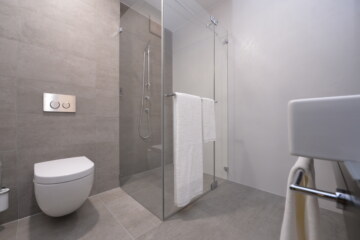 Minimalist bathroom in a modern hotel room in Munich.
